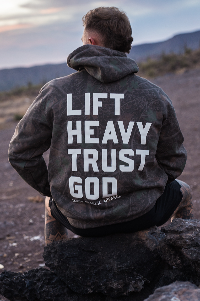 Lift Heavy. Trust God. - Premium Darkwood Camo Hoodie